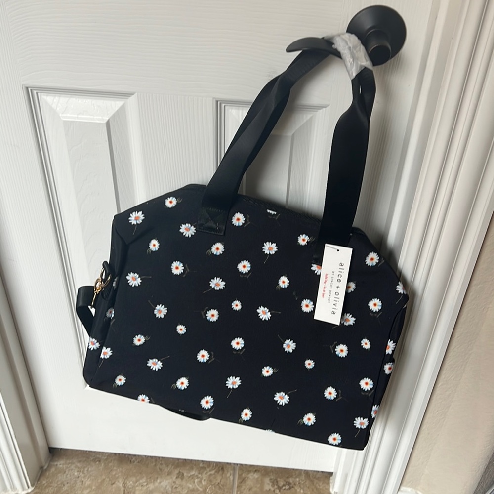 Alice and Olivia duffel bag. NWT. Black with daisy print.